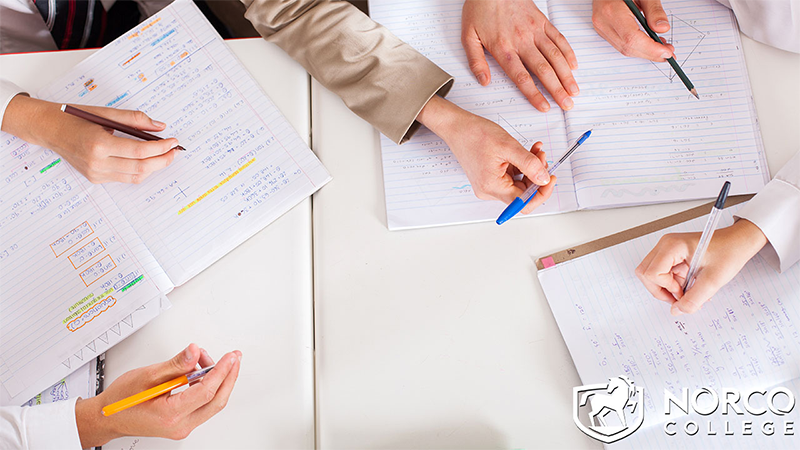 Overhead view of teacher tutoring students in classroom