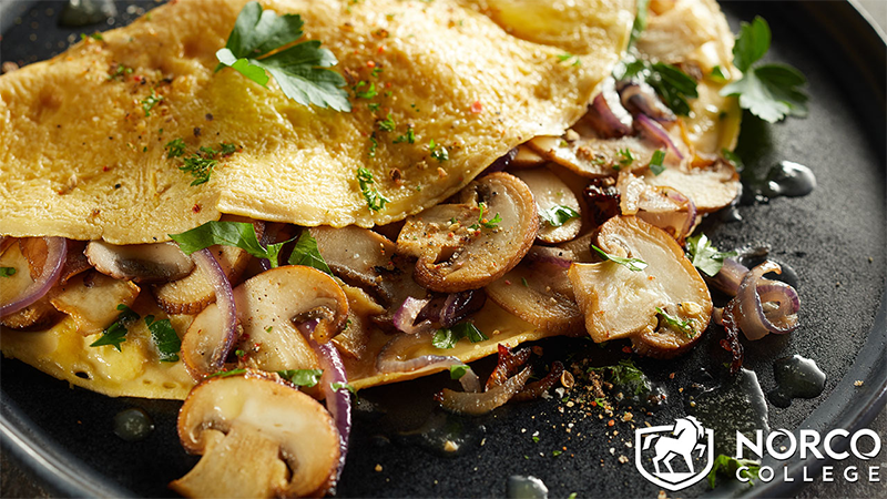 Tasty omelette with mushrooms on plate