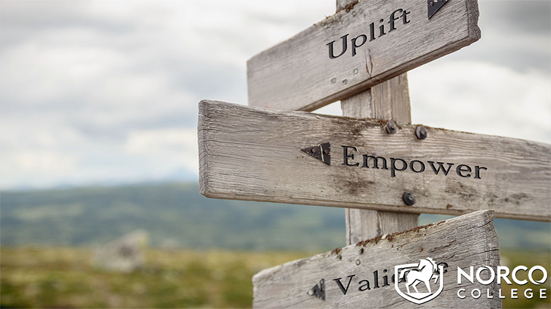 Image of sign with the words uplift and empower