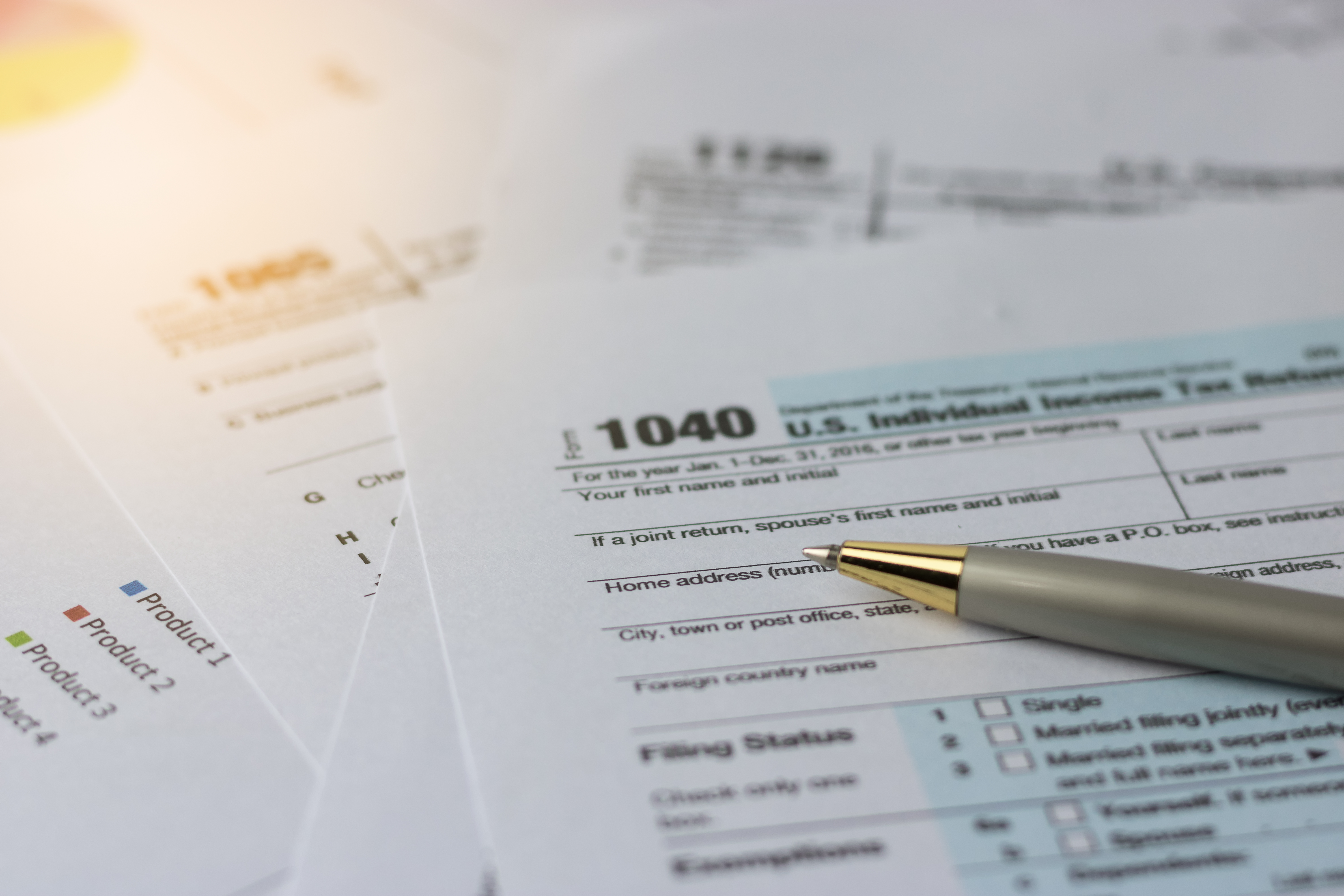 Stock image of pen on top of tax forms