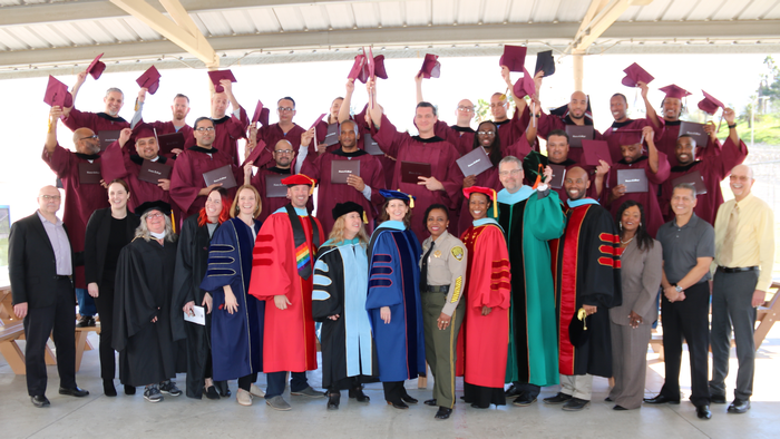 Prison Education Program graduates hats off with leadership