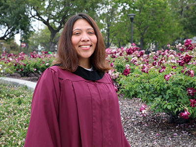Danelia Fernandez on Norco College campus in commencement regalia