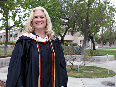Professor Melissa Bader on Norco College campus in commencement regalia Professor Melissa Bader on Norco College campus in commencement regalia